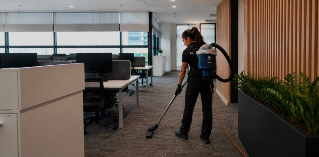 FocusX cleaner vacuuming the carpet of an open-plan Melbourne office